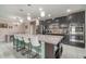 A large kitchen island features seating and overlooks the adjacent breakfast bar at 3705 Apopka Ridge Cir, Apopka, FL 32703
