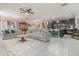 Open-concept living room featuring tile floors, a ceiling fan and a kitchen with a breakfast bar at 3705 Apopka Ridge Cir, Apopka, FL 32703