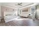 Spacious main bedroom boasts wood floors, tray ceilings, and a ceiling fan for added comfort at 3705 Apopka Ridge Cir, Apopka, FL 32703