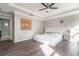 Bright main bedroom features hardwood floors, tray ceiling, ceiling fan, and ample natural light at 3705 Apopka Ridge Cir, Apopka, FL 32703