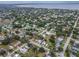 Aerial view showcasing homes nestled between tree lined streets, near the coast at 406 10Th St, St Cloud, FL 34769