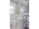 Neutral bathroom featuring a modern sink, a large mirror, and a frosted window at 406 10Th St, St Cloud, FL 34769