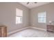Neutral bedroom with two windows, light wood floors, and ceiling fan at 406 10Th St, St Cloud, FL 34769