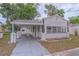 Charming home featuring a carport, well-maintained lawn, and classic siding at 406 10Th St, St Cloud, FL 34769
