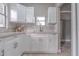 Modern kitchen featuring white cabinets, granite countertops, and a stylish backsplash at 406 10Th St, St Cloud, FL 34769