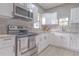 Updated kitchen boasting stainless steel appliances, white cabinets, and modern fixtures at 406 10Th St, St Cloud, FL 34769