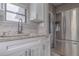 Well-lit kitchen featuring granite countertops, stainless steel refrigerator, and modern faucet at 406 10Th St, St Cloud, FL 34769