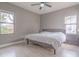 Bedroom with two windows, light wood floors, ceiling fan, and a bed at 406 10Th St, St Cloud, FL 34769