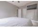 Bedroom featuring a ceiling fan, television, closet, and light wood floors at 406 10Th St, St Cloud, FL 34769