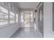 Bright, enclosed sunroom featuring paneled walls, windows, and a secure front door at 406 10Th St, St Cloud, FL 34769