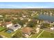Aerial view shows homes next to a pond or lake with well-kept landscaping at 4061 Flowering Peach Ln, St Cloud, FL 34772