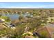 An aerial showcases the community of houses, a lake, and green landscaping at 4061 Flowering Peach Ln, St Cloud, FL 34772