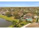 Aerial view of the home featuring a private pool, fenced yard, and waterfront access at 4061 Flowering Peach Ln, St Cloud, FL 34772
