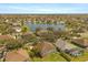 Wide aerial showcasing neighborhood homes surrounding a large pond or small lake at 4061 Flowering Peach Ln, St Cloud, FL 34772