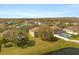 Aerial view of a home with a pool and a large green yard and a pond or lake at 4061 Flowering Peach Ln, St Cloud, FL 34772