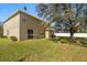 A home's backyard with a mature shade tree and fenced perimeter at 4061 Flowering Peach Ln, St Cloud, FL 34772