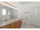 Bright bathroom featuring double sinks, a large mirror, and tile floors at 4061 Flowering Peach Ln, St Cloud, FL 34772