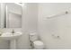 Clean and simple half bathroom with pedestal sink and neutral tones at 4061 Flowering Peach Ln, St Cloud, FL 34772