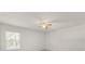 Cozy bedroom with a window, ceiling fan, and neutral carpet at 4061 Flowering Peach Ln, St Cloud, FL 34772