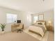 Bright bedroom with a bed, desk, and neutral decor at 4061 Flowering Peach Ln, St Cloud, FL 34772