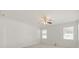 Bedroom with neutral carpet, two windows for light, and a ceiling fan at 4061 Flowering Peach Ln, St Cloud, FL 34772