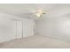 A bright bedroom features neutral carpet, a ceiling fan, and a closet with bi-fold doors at 4061 Flowering Peach Ln, St Cloud, FL 34772
