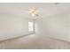 Bright bedroom featuring neutral carpet, ceiling fan, and natural light from the window at 4061 Flowering Peach Ln, St Cloud, FL 34772