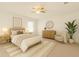 Stylishly staged bedroom with ample natural light and ceiling fan at 4061 Flowering Peach Ln, St Cloud, FL 34772