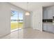 Bright dining area features tile floors, sliding glass doors, and a view of the lake at 4061 Flowering Peach Ln, St Cloud, FL 34772