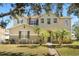 Inviting two-story home featuring a well-maintained lawn and decorative palm trees at 4061 Flowering Peach Ln, St Cloud, FL 34772