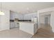 Kitchen with light blue cabinets, an island, and access to the living room at 4061 Flowering Peach Ln, St Cloud, FL 34772