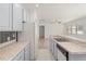 Well-lit kitchen showcases white appliances, countertops, and view into the living room at 4061 Flowering Peach Ln, St Cloud, FL 34772