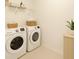 Convenient laundry room with modern appliances and storage at 4061 Flowering Peach Ln, St Cloud, FL 34772
