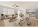Sun-filled living room with backyard access and a breakfast nook adjacent to the modern kitchen at 4061 Flowering Peach Ln, St Cloud, FL 34772