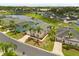 Lovely aerial view of a community with backyard pools, screened enclosures, and lush landscaping near a lake at 407 Reserve Dr, Davenport, FL 33896