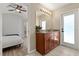 Bathroom vanity with wood cabinetry, granite countertops, and modern lighting at 407 Reserve Dr, Davenport, FL 33896