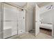 Bathroom featuring a glass-enclosed shower with built-in seat and tile flooring at 407 Reserve Dr, Davenport, FL 33896
