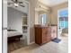 This bathroom features a granite-topped vanity, tile flooring, and access to the pool area at 407 Reserve Dr, Davenport, FL 33896