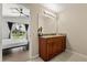 Bathroom vanity featuring wood cabinetry, granite countertops, and modern lighting at 407 Reserve Dr, Davenport, FL 33896