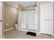 Bright bathroom featuring a tiled walk-in shower with glass doors, adjacent to a linen closet at 407 Reserve Dr, Davenport, FL 33896