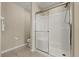 Bathroom featuring a glass-enclosed shower with built-in seat and tile flooring at 407 Reserve Dr, Davenport, FL 33896