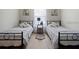 Clean bedroom with two beds, gray linens, and a nightstand in between at 407 Reserve Dr, Davenport, FL 33896