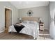 Cozy bedroom featuring light gray walls, decorative wall art, and bedside lamps at 407 Reserve Dr, Davenport, FL 33896