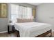 Bright bedroom with a bed dressed in white linens, with natural light from the window at 407 Reserve Dr, Davenport, FL 33896