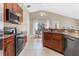 Modern kitchen featuring sleek appliances, granite countertops, and ample cabinet space at 407 Reserve Dr, Davenport, FL 33896