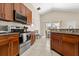 Well-equipped kitchen with stainless steel appliances, and sleek countertops connecting to the dining space at 407 Reserve Dr, Davenport, FL 33896