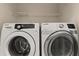 Modern laundry room equipped with high-efficiency Samsung washer and dryer, perfect for easy chore management at 407 Reserve Dr, Davenport, FL 33896