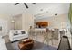 Spacious living area open to the kitchen and dining room, featuring modern decor and neutral tones at 407 Reserve Dr, Davenport, FL 33896