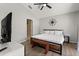 Bedroom featuring wood-look floors, ceiling fan, and en suite bathroom entrance at 407 Reserve Dr, Davenport, FL 33896