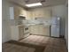 Bright kitchen with white appliances, tile floors and ample counter space at 4179 Spitfire Ave, Kissimmee, FL 34741